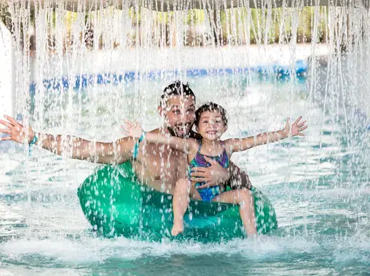father and daughter is in the lazy river at centara mirage beach resort dubai