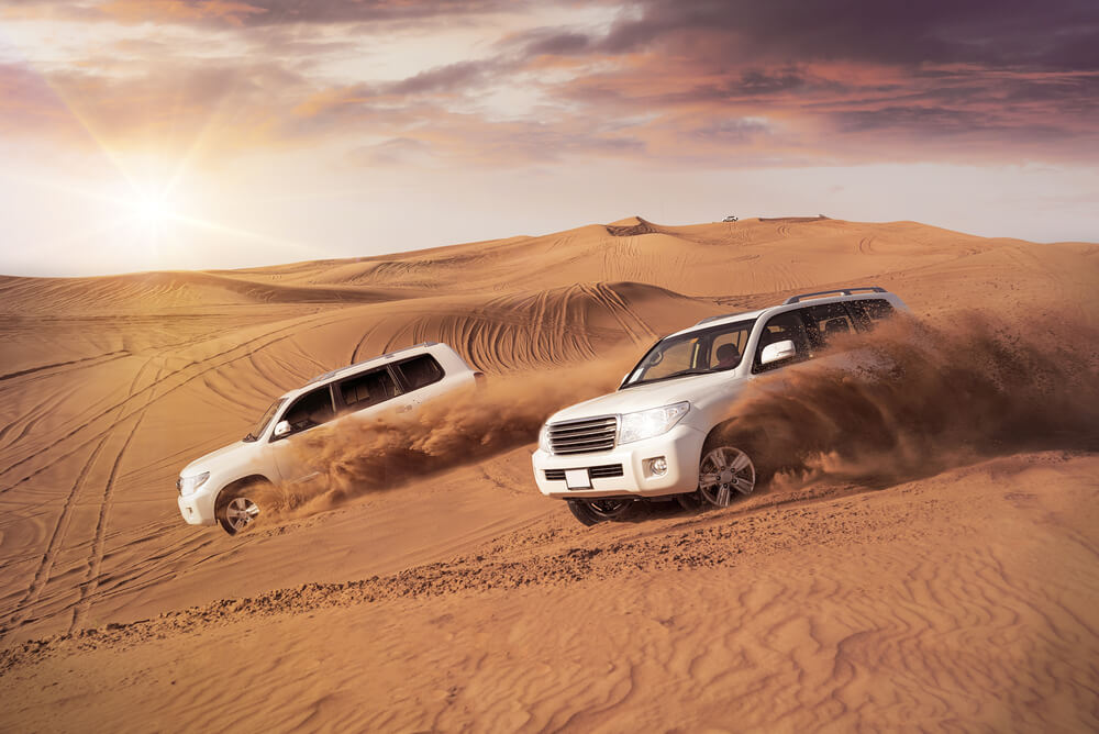 Two cars sand dune bashing in the Dubai desert 