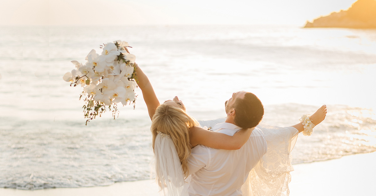 A happy newlywed couple on a beach